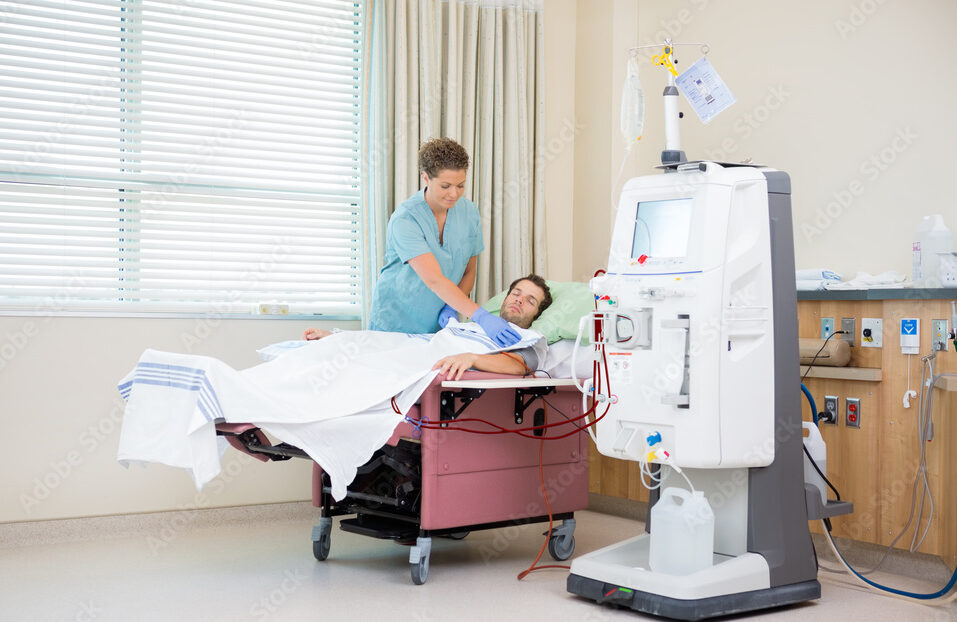 Nurse Covering Patient Receiving Renal Dialysis With Blanket